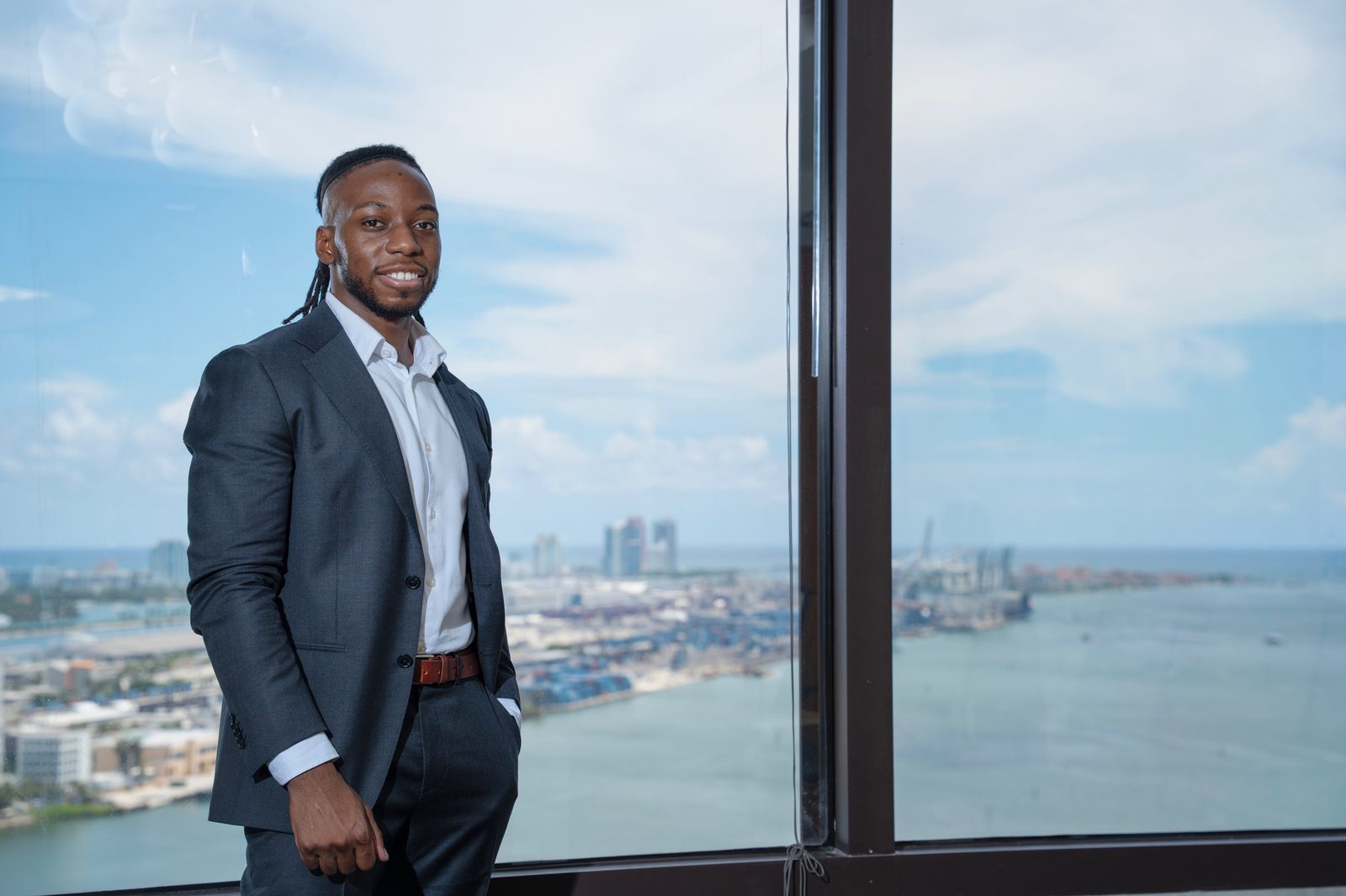 Emmanuel Udotong at a window overlooking the Port of Miami